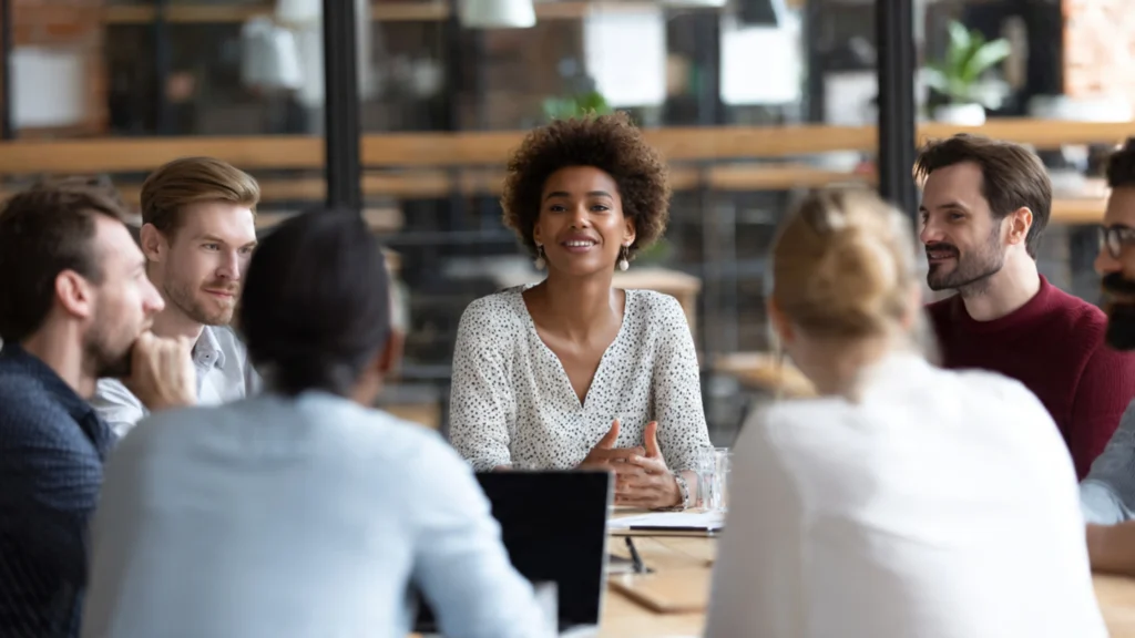 a diverse group of professionals in a formal meeting setting
