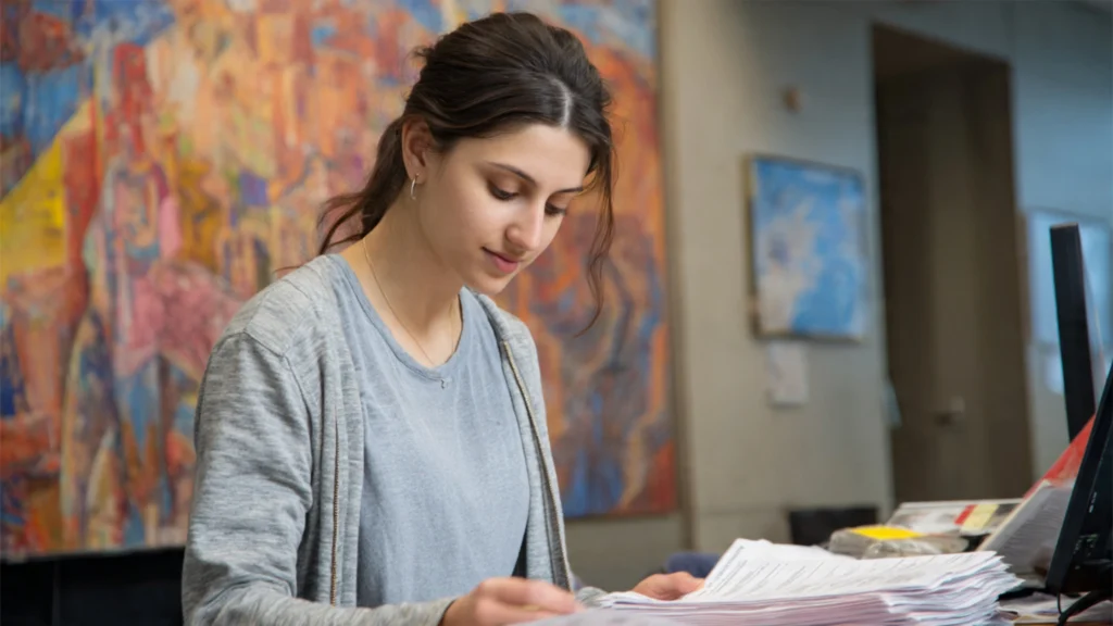 international student reviewing documents at a campus advising office