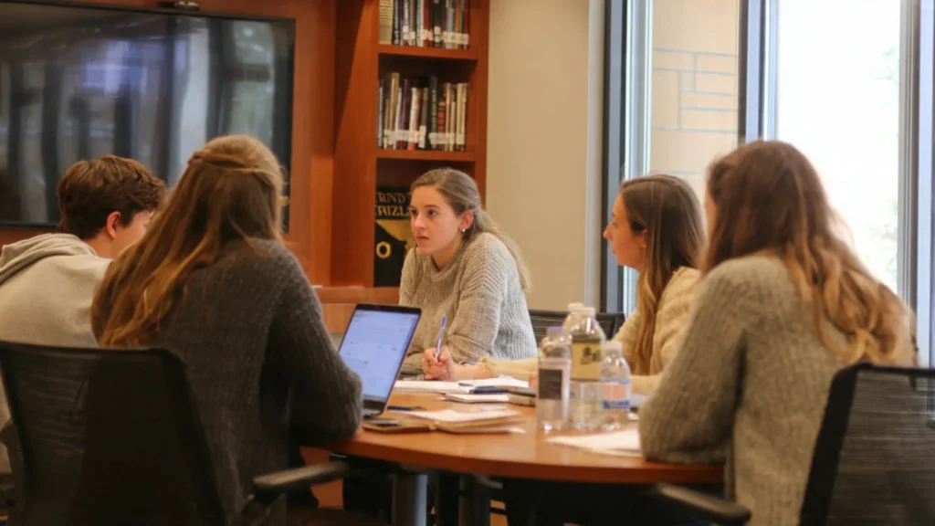 interns collaborating around a table in a Siena seminar room here